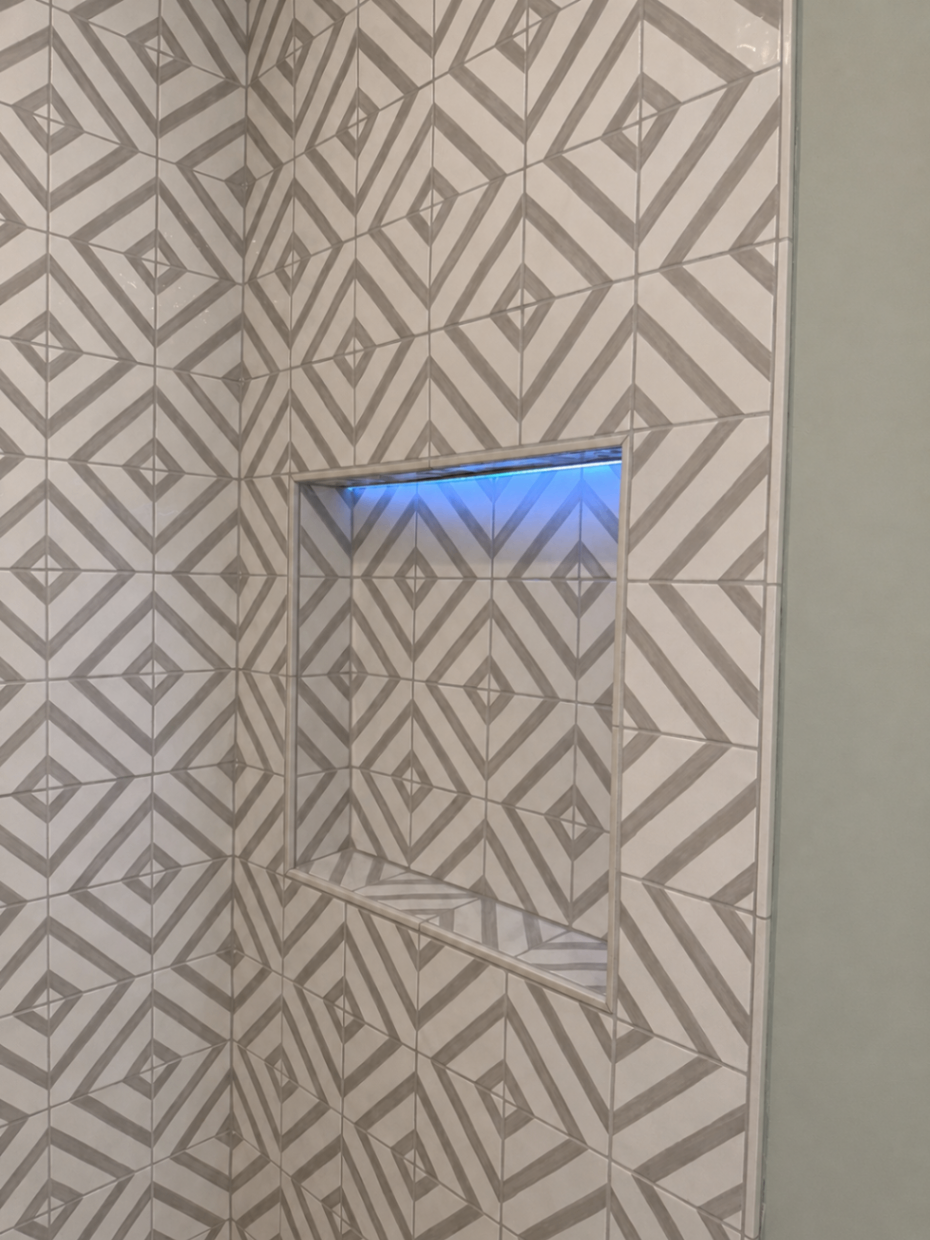 Geometric tiles and glowing niche — R. Da Silva Construction bathrooms project, Marin County & East Bay